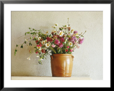 Summer Arrangement Of Wild Flowers In Glazed Jar Against Whitewashed Wall by Martine Mouchy Pricing Limited Edition Print image