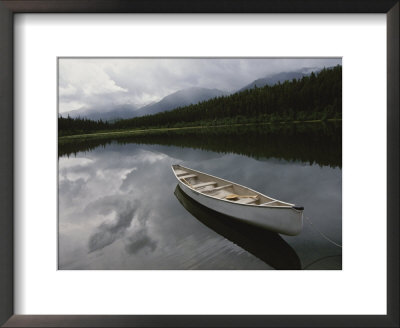 A Canoe Sits Tethered To Shore On A Beautiful Mountain Lake by Raymond Gehman Pricing Limited Edition Print image