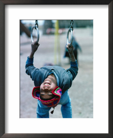 Aymara Boy Playing In Playground, Chucuito, Puno, Peru by Eric Wheater Pricing Limited Edition Print image