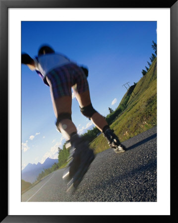 Woman Roller-Blading Along Mountain Road, Canada by Philip Smith Pricing Limited Edition Print image