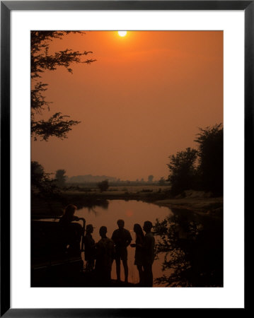 People On Banks Of Zambezi River, Zambia by Roger De La Harpe Pricing Limited Edition Print image