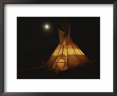 A Tepee Is Illuminated Against The Night Sky by Michael Melford Pricing Limited Edition Print image