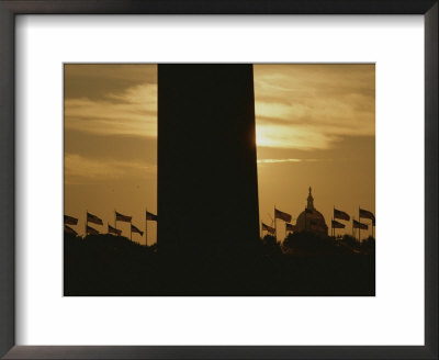 A Twilight View Of American Flags Flying At The Washington Monument by Karen Kasmauski Pricing Limited Edition Print image