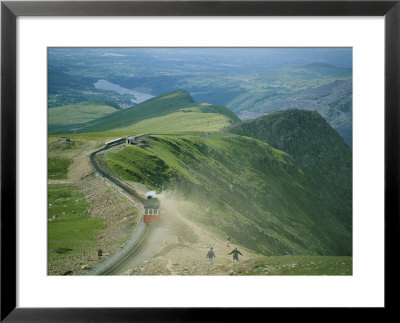 A Train Carrying Tourists Chugs Up Snowdon Mountain In Wales by Joel Sartore Pricing Limited Edition Print image