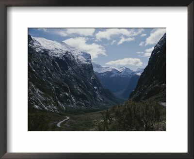 Snow-Capped Mountains Behind Winding Road by Todd Gipstein Pricing Limited Edition Print image
