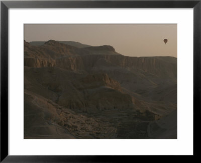 A Hot-Air Balloon In Flight Over Egypts Valley Of The Kings by Kenneth Garrett Pricing Limited Edition Print image