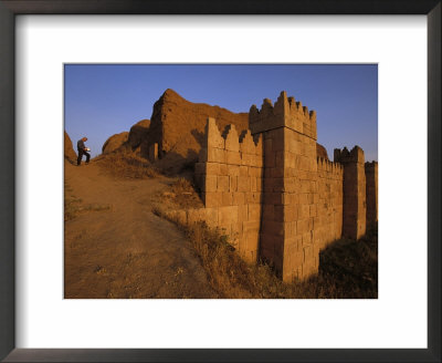 A Man Writes While Standing Near The Massive Walls Of Nineveh by Randy Olson Pricing Limited Edition Print image