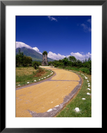Rice Drying On Side Of Road With Cagsawa Church Tower And Mayon Volcano In Background, Philippines by John Pennock Pricing Limited Edition Print image