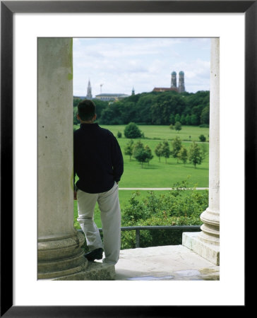 A Man Stands Looking At The English Garden In Munich by Taylor S. Kennedy Pricing Limited Edition Print image
