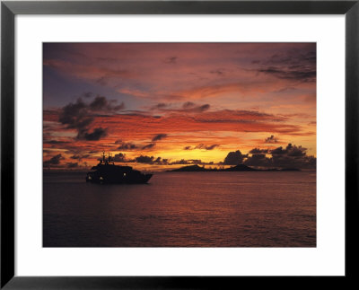 A Passenger Boat Silhouetted On Truk Lagoon At Sunset by Heather Perry Pricing Limited Edition Print image