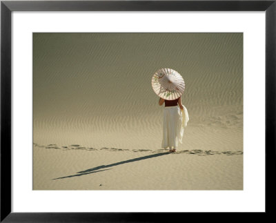 Lady With Parasol Standing In Sand Dunes And Casting A Shadow by Kate Thompson Pricing Limited Edition Print image