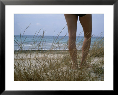 Legs Of A Woman Standing On A Dune Overlooking The Mediterranean by Taylor S. Kennedy Pricing Limited Edition Print image