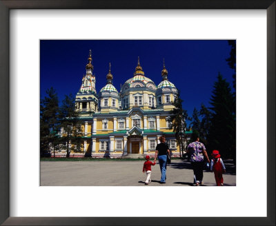 Family Walking Outside Zenkov Cathedral In Panfilov Park, Almaty, Kazakhstan by Anthony Plummer Pricing Limited Edition Print image
