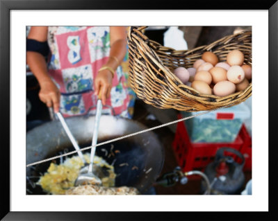 Basket Of Eggs Hanging In Front Of Woman Cooking Asian Stir-Fry, Rapid Creek Market, Australia by Will Salter Pricing Limited Edition Print image