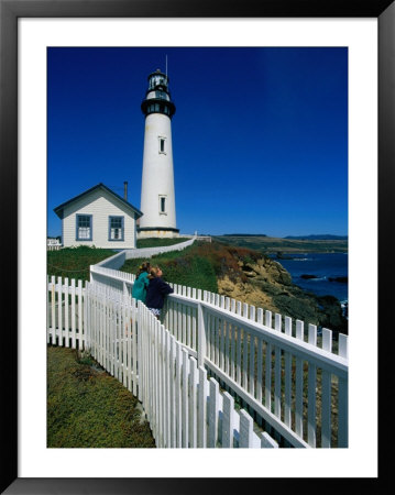 Two Girls Leaning On Railing At Pigeon Point Lighthouse, San Mateo County, Usa by Mark & Audrey Gibson Pricing Limited Edition Print image