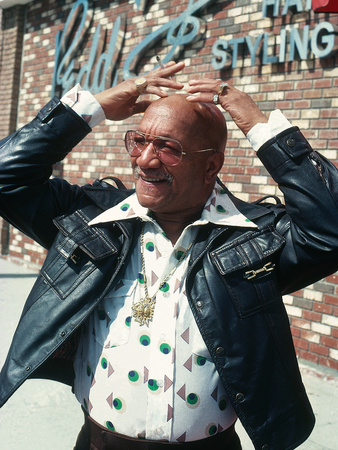 Redd Foxx Stands In Front Of The Redd Foxx Hair And Styling Salon by Isaac Sutton Pricing Limited Edition Print image