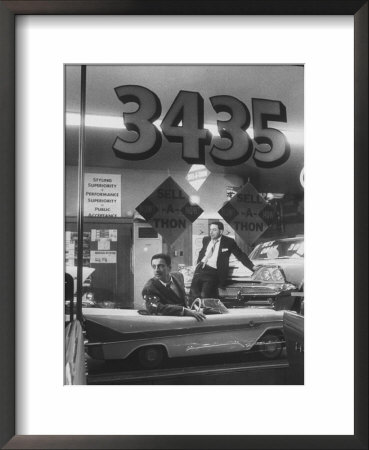 Men Standing In The Window Of A Car Dealership by Francis Miller Pricing Limited Edition Print image