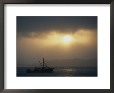 A Fishing Boat Heads Out To Sea At Sunrise by Norbert Rosing Pricing Limited Edition Print image