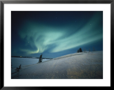 The Aurora Borealis Creates Swirls Of Light Across The Sky by Paul Nicklen Pricing Limited Edition Print image