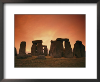 The Setting Sun Casts An Eerie Glow Over Stonehenge by Richard Nowitz Pricing Limited Edition Print image