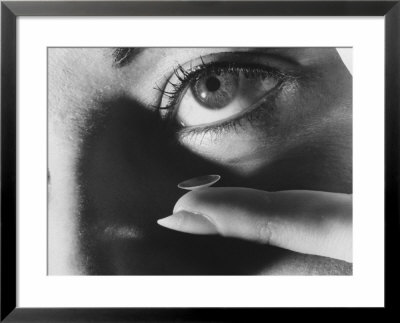 Woman Preparing To Insert Contact Lens Into Her Eye by Henry Groskinsky Pricing Limited Edition Print image