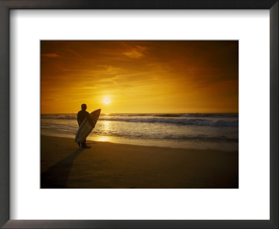 Surfer Holding Surfboard On Beach At Sunset by Doug Mazell Pricing Limited Edition Print image
