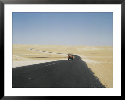 The Meandering Asphalt Road Between Hofuf And Riyadh Is Partly Laid On Gravel And Partly On Sand by W. Robert Moore Pricing Limited Edition Print image