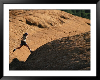 A Woman Hikes On Red Rocks In Northern Arizona by Dugald Bremner Pricing Limited Edition Print image