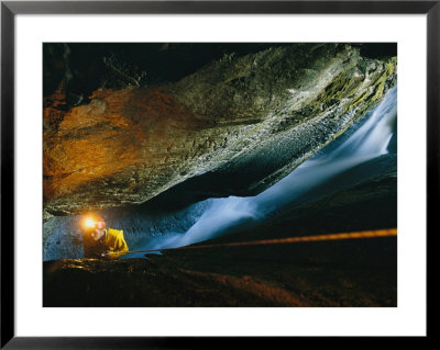 Cave Explorer Climbs Through One Of The Madre De Dios Island Caves by Peter Carsten Pricing Limited Edition Print image