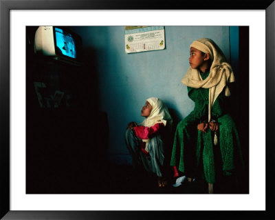 Muslim Girls Relax Watching Television, Indonesia by Adams Gregory Pricing Limited Edition Print image