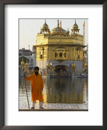 Shrine Guard In Orange Clothes Holding Lance Standing By Pool In Front Of The Golden Temple by Eitan Simanor Pricing Limited Edition Print image