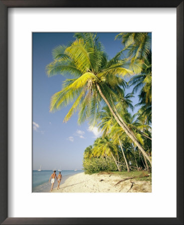 Couple Strolls Down The Beach Beneath Swaying Palm Trees, Maracas Bay, Trinidad And Tobago by Richard Nowitz Pricing Limited Edition Print image