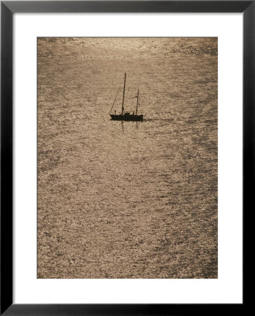 A Silhouetted Sailboat On Sun Reflected Water, Cinque Terre by Raul Touzon Pricing Limited Edition Print image