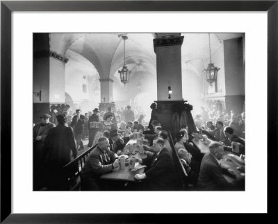 The Hofbrauhaus With Patrons Sitting At Long Tables Holding Large Steins Of Beer by Ralph Crane Pricing Limited Edition Print image