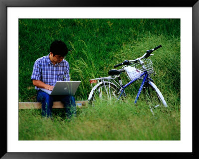 Man Using Laptop Computer Beside His Bicycle Near Kamogawa River, Kyoto, Japan by Frank Carter Pricing Limited Edition Print image