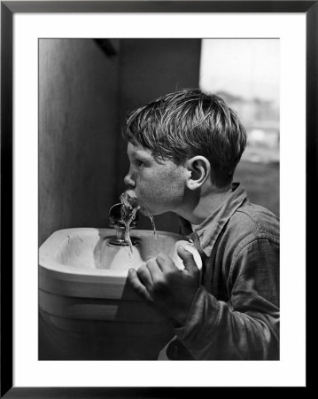 Young Boy Drinking From A Water Fountain by Allan Grant Pricing Limited Edition Print image