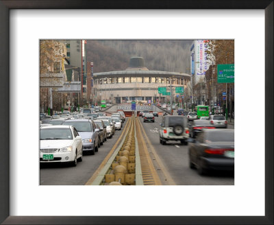 Traffic In Front Of Seoul Arts Centre, Seoul, South Korea by Anthony Plummer Pricing Limited Edition Print image