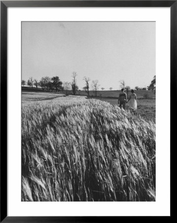 Young Couple Walking By A Grain Field by Ed Clark Pricing Limited Edition Print image