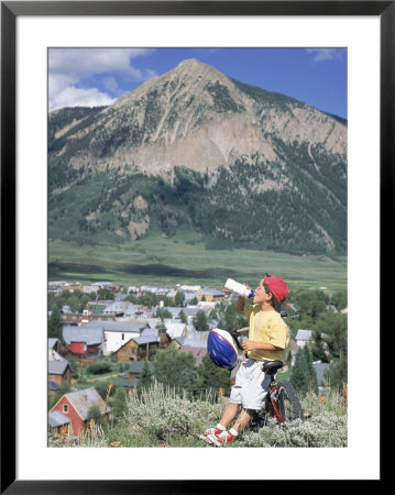 Boy Resting With Mountain Bike, Crested Butte, Co by Tom Stillo Pricing Limited Edition Print image