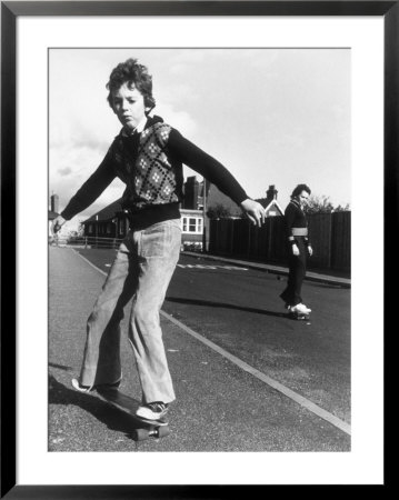 Boy Balances On His Skateboard With A Look Of Concentration On His Face by Gill Emberton Pricing Limited Edition Print image