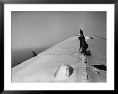 Maintenance Crewmen On Top Of Graf Zeppelin Repair Damage Caused Atlantic Ocean Storm During Flight by Alfred Eisenstaedt Pricing Limited Edition Print image