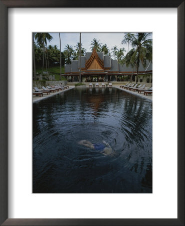 A Swimmer Takes A Relaxing Dip In A Resort Pool by Jodi Cobb Pricing Limited Edition Print image