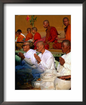 Nuns Praying At Pha That Luang Temple During The Full Moon Temple Festival, Vientiane, Laos by Juliet Coombe Pricing Limited Edition Print image