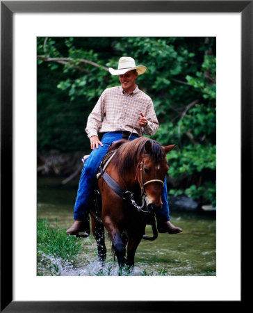 Cowboy On Horse In Medina River, Mayan Dude Ranch, Bandera, Texas by Holger Leue Pricing Limited Edition Print image