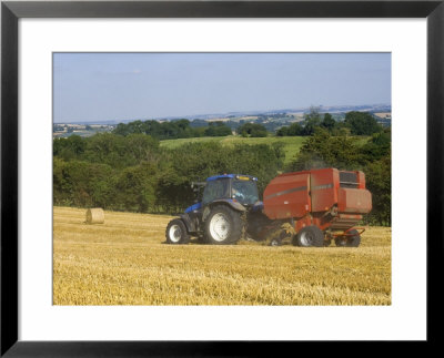 Tractor Collecting Hay Bales At Harvest Time, The Coltswolds, England by David Hughes Pricing Limited Edition Print image