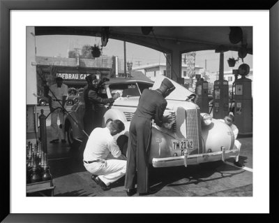 Muller Brothers Service Station's Attendants Pumping Gas And Inflating Tires On A Fancy Convertible by Peter Stackpole Pricing Limited Edition Print image