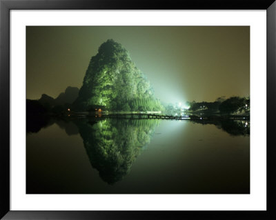 A Large Rock Formation Or Mountain On Shore Of Star Lake At Night by Raymond Gehman Pricing Limited Edition Print image