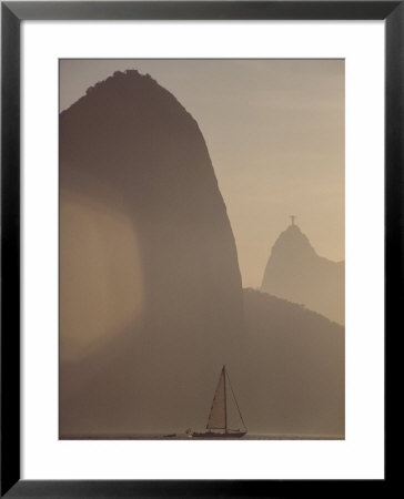 Sugar Loaf Mountain Towers Above A Sailboat On Guanabara Bay by Stephanie Maze Pricing Limited Edition Print image
