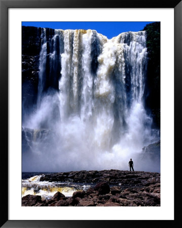 Person Standing In Front Of Aponguao Falls (Chinak Meru), Gran Sabana, Venezuela by Krzysztof Dydynski Pricing Limited Edition Print image