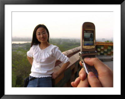 In Jingshan Park, A Man Takes A Photo Using His Mobile Phone by Richard Nowitz Pricing Limited Edition Print image